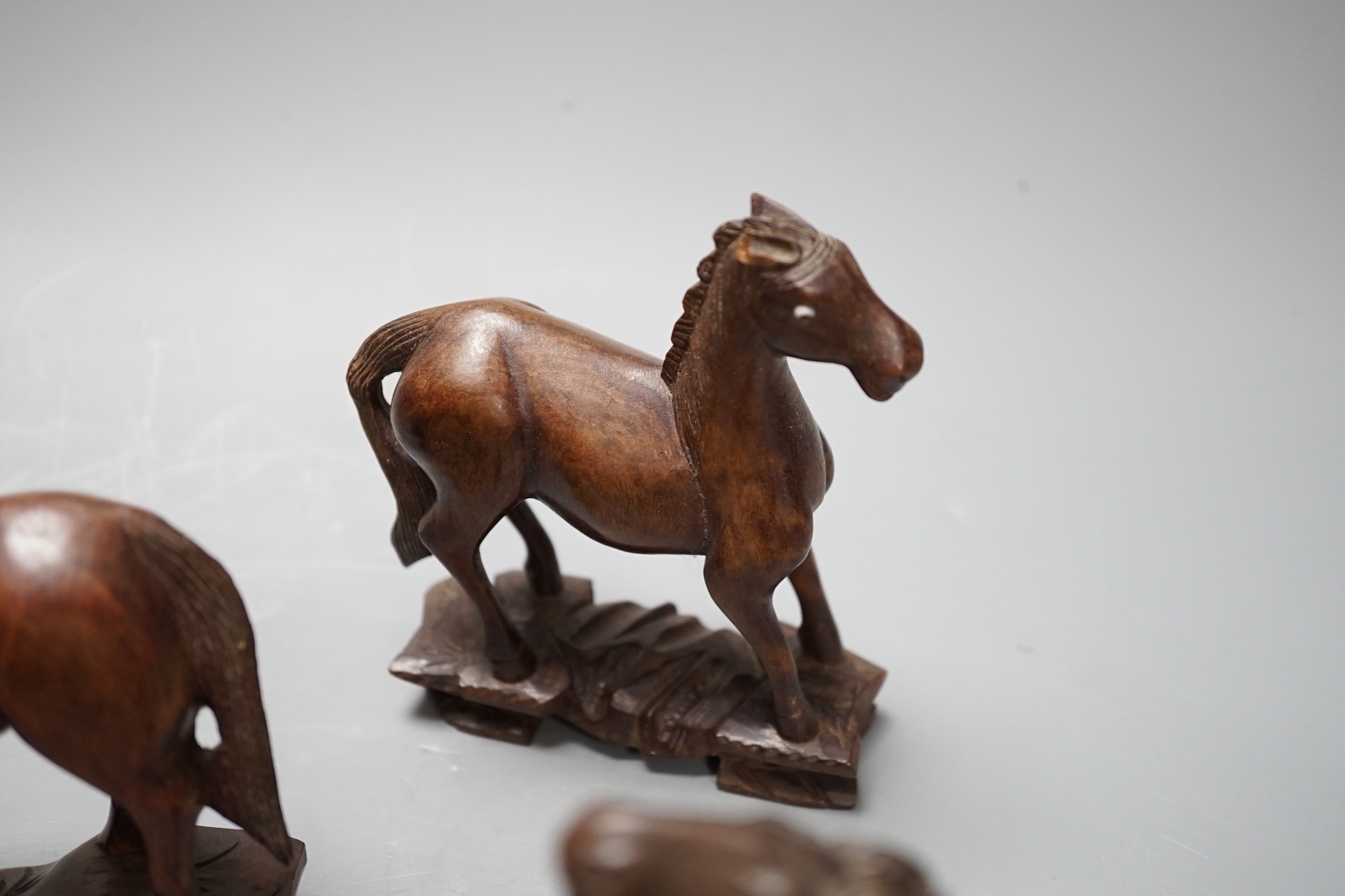 Seven Chinese hardwood models of horses. Tallest 13cm